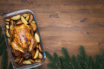 Roasted Christmas Chicken or Turkey for Christmas Dinner  on wooden background with copy space.