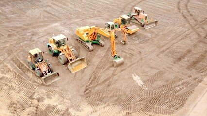 Construction machinery, excavator, wheel loader, roller, bulldozer on a construction site from a...