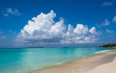 Beautiful image of tropical beach image taken from Maldives beach, turquoise ocean with clear sand and  awesome clouds on the background