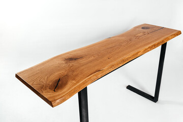 Handmade wooden table on metal racks on a white background