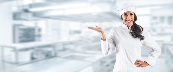 A young chef's right hand draws attention to an offer in restaurant kitchen