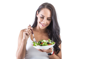 Beautiful woman holding a fork and eating healthy vegetarian salad