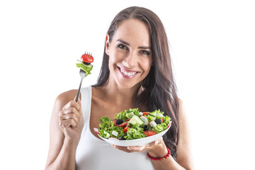 Smiling brunette holding a fork and eating healthy vegetarian salad