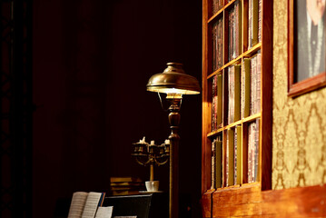 Old library with retro lamp, piano, music sheets, candlestick, books, theatre decoration on stage
