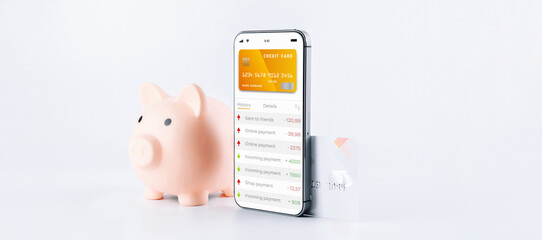 Internet based banking. Mobile phone with internet online bank app. Pig bank with credit card on...