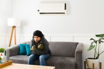 Young man freezing at home