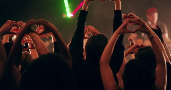 Its time to fall in love with life. 4k video footage of a crowd of people making heart shaped gestures during a live musical performance.