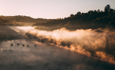 Obraz na płótnie Canvas Sunrise with fog over Ban Rak thai, chinese village near a lake in Mae Hong Son, Thailand