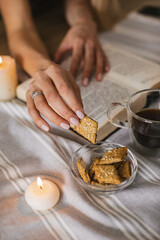 Still life with a Cup of coffee, cookies, candles and a book. The atmosphere of a cozy morning Breakfast at home or in a cafe.