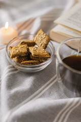 Still life with a Cup of coffee, cookies, candles and a book. The atmosphere of a cozy morning Breakfast at home or in a cafe.