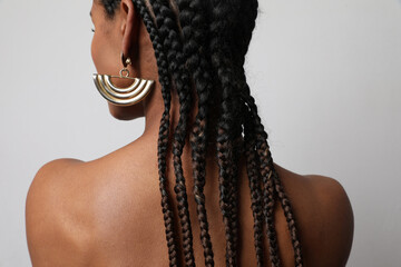 Close-up of African young woman with dark braids posing on white background. - obrazy, fototapety, plakaty