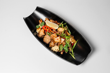 Teriyaki, Asian food, Chinese dishes, teriyaki on a black long plate with microgreens