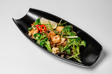 Teriyaki, Asian food, Chinese dishes, teriyaki on a black long plate with microgreens
