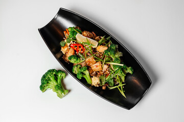 Teriyaki, Asian food, Chinese dishes, teriyaki on a black long plate with microgreens