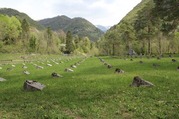 Cemetery with grass and mountains. Peaceful landscape 