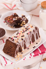 Sponge cake with white frosting and sugars.