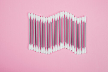 Cotton buds on a pink background