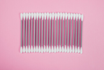 Cotton buds on a pink background