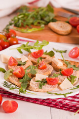 Friselle with cherry tomatoes and arugula.