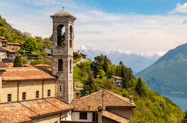 Fototapeta na wymiar Bell tower of the parish church of Saints Simone and Fedele, located in Brè-Aldesago on the Monte Bre of Lugano,Ticino, Switzerland