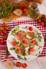Friselle with cherry tomatoes and arugula.