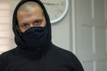 Bald man with with hood and mask