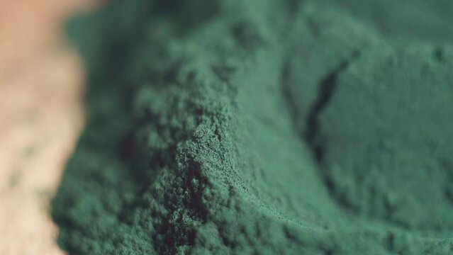 Spirulina algae powder close up. Superfood concept. Macro photography. Selective focus