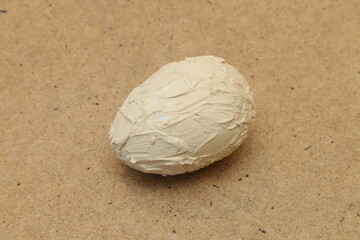 Artificial egg covered with plaster.
