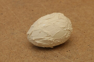 Artificial egg covered with plaster.