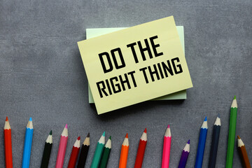 Do the right thing text on a yellow sticky note on a gray background colorful pencils background