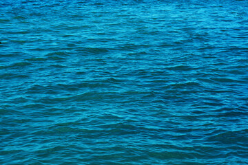 .small waves on the surface of the blue water
