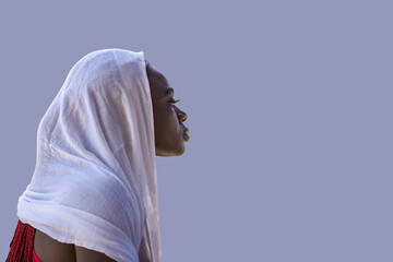 African Ghana woman standing with a white shawl covering her hair