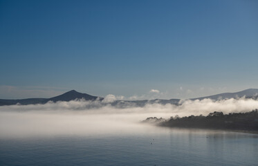 Foggy landscape view of Kiliney Bay, Dublin and Sugarloaf Mountain in Wicklow, Ireland 