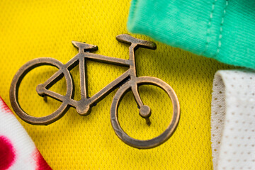 Golden bike pin on some colorful tour de france t-shirts