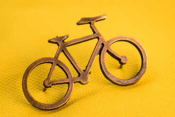 Fototapeta na wymiar Golden bike pin on yellow tour de france t-shirt