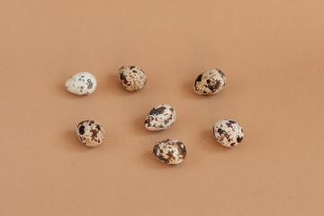 Quail eggs on a beige background, top view. Minimalist egg design, modern design template.