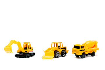 Naklejka premium Little mini yellow plastic concrete mixer,excavator tractor,truck lorry,car automobile toy isolated on white background mockup with copy space,toys for children,kids development,playing,childhood fun