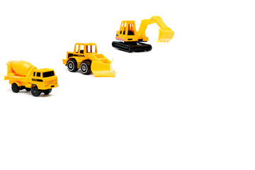 Little mini yellow plastic concrete mixer,excavator tractor,truck lorry,car automobile toy isolated on white background mockup with copy space,toys for children,kids development,playing,childhood fun
