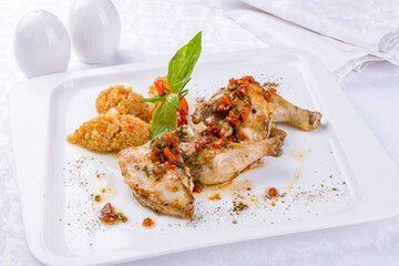 fried chicken tobacco with kinoa on a white plate