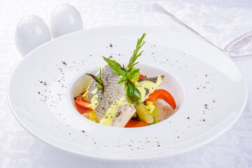 fried fish muksun on a white plate