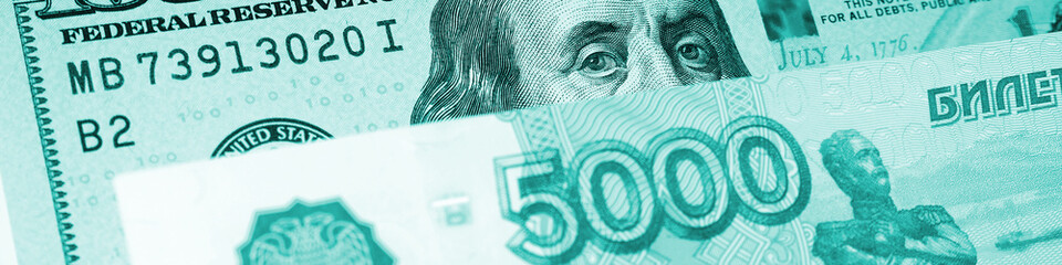 Fragments of Russian and US paper money close-up. Ruble and dollar. Banknote of 5000 rubles and note of 100$ dollars. Turquoise tinted banner or header about exchange rate. News of economy. Macro