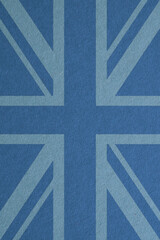 British flag outline on blue cardboard surface. Paper texture with cellulose fibers. Paperboard...