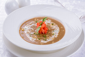 cream of porcini mushroom soup on a white plate