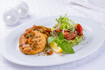 fish cutlets with pike perch and salmon on a white plate
