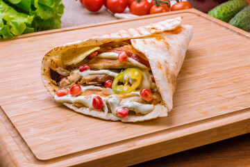 Gyros with chicken Greek cuisine on wooden table