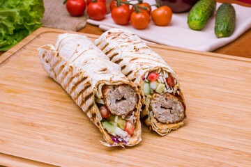 roll with beef lula kebab with vegetables on the Board
