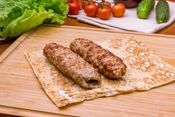 Lamb Lula kebab on the board macro close up