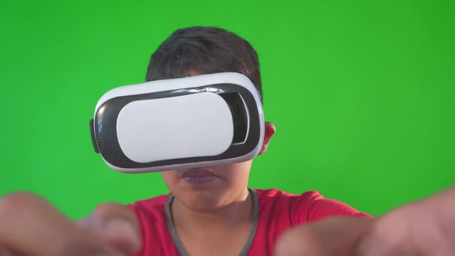 a boy playing game in virtual reality goggles on a Green Screen