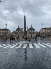 Fototapeta na wymiar Aesthetic photo of the Piazza del Popolo in Rome, its obelisk and the broken church on a rainy day