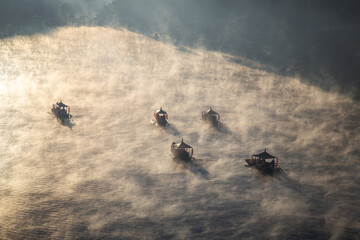 Sunrise with fog over Ban Rak thai, chinese village near a lake in Mae Hong Son, Thailand
